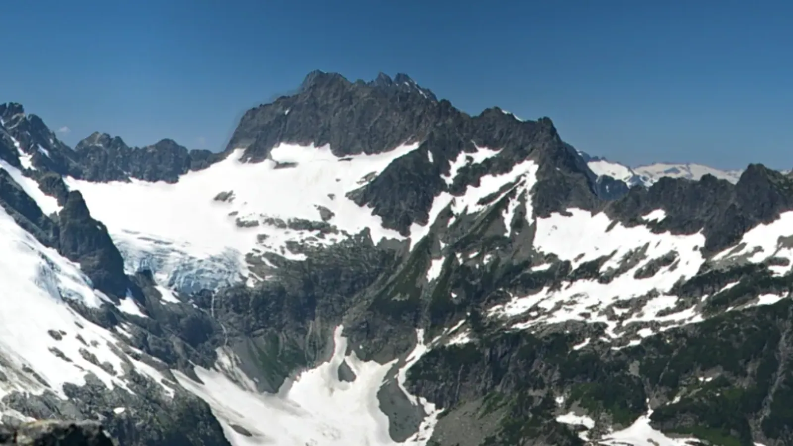 Serratus Mountain in the Tantalus Range, a snow and rock summit seen across a glaciated basin from Mount Niobe.