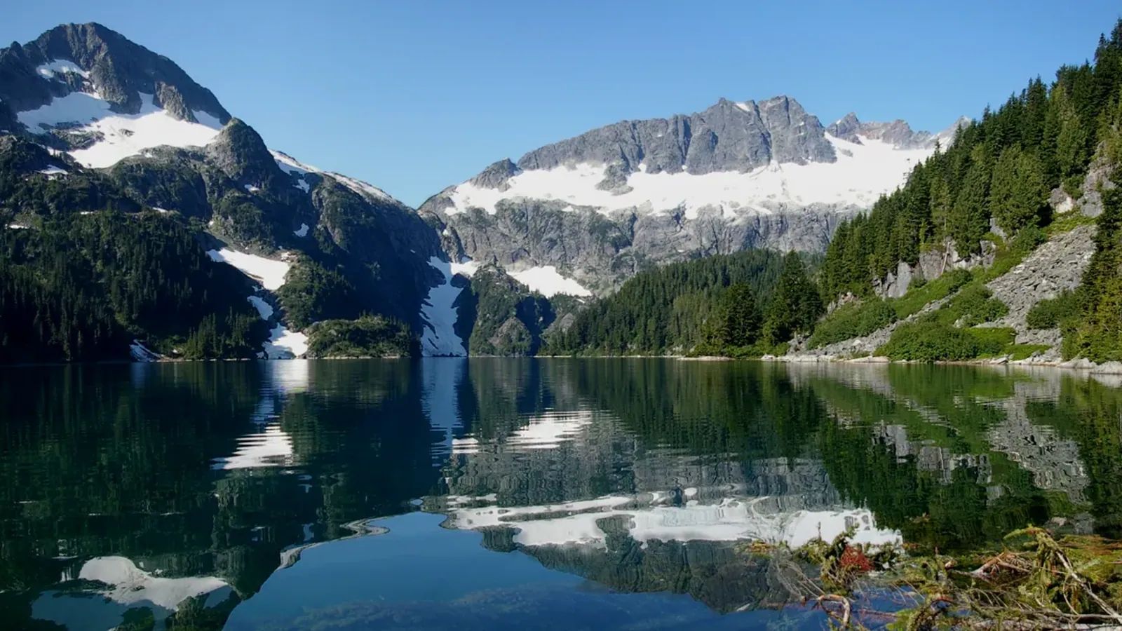 Lake Lovely Water in the Tantalus Range, with Mount Niobe and Lydia Mountain rising above the far shore.